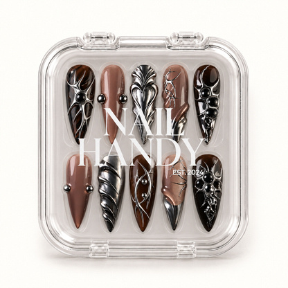 Closed clear Nail Handy case displaying ten coordinated mocha and taupe nails with reflective silver-toned details and black rounded accents.
