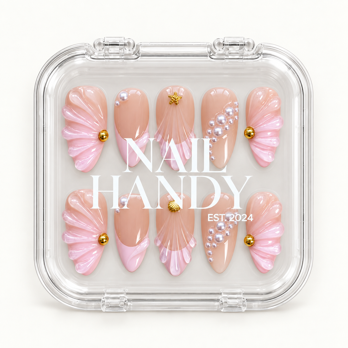 Closed clear Nail Handy display box showing ten nude blush and pink nails with raised shell fans, pearl-like embellishments, and gold-tone accents.