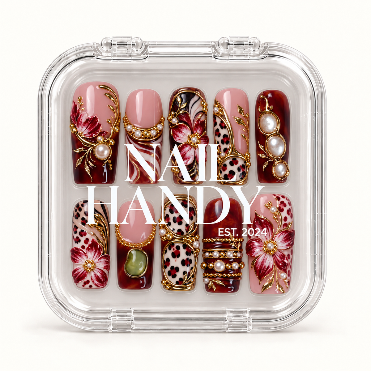 Closed clear case with white Nail Handy lettering, displaying ten coordinated burgundy and blush nails with flowers, leopard spots, and pearl-like accents.