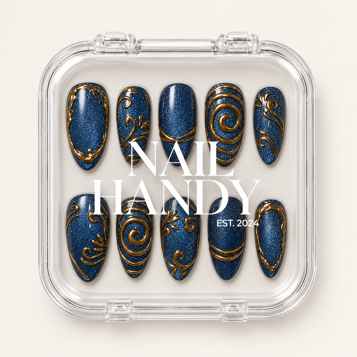 Clear Nail Handy case displaying two rows of deep blue shimmer nails with gold scroll and border designs.