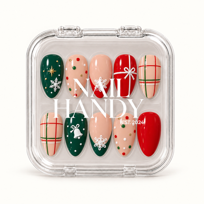 Closed clear Nail Handy case displaying ten Christmas nails with snowflakes, plaid, a gift bow, a bell, and red and evergreen accents.