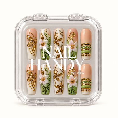 Closed clear display case holding ten coordinated sage, peach nude, and ivory floral nails beneath large white lettering on the lid.