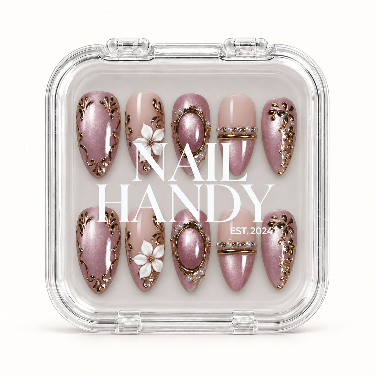 Closed clear Nail Handy case displays ten coordinated mauve and blush nude nails beneath white branding, with floral and gold-toned ornamental details.