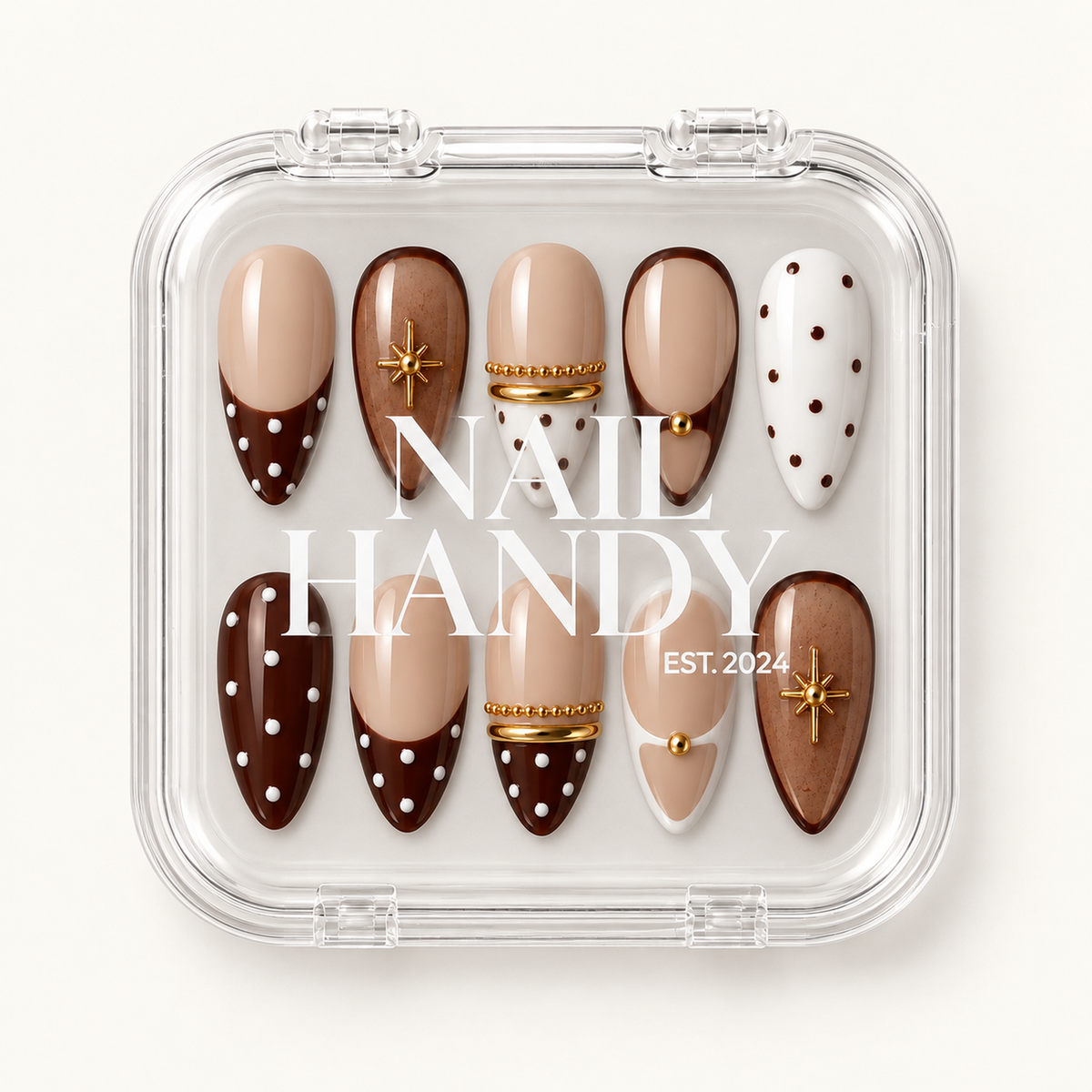 Closed clear case with white Nail Handy lettering displaying ten coordinated nude, cocoa, and cream nails with polka dots and gold accents.