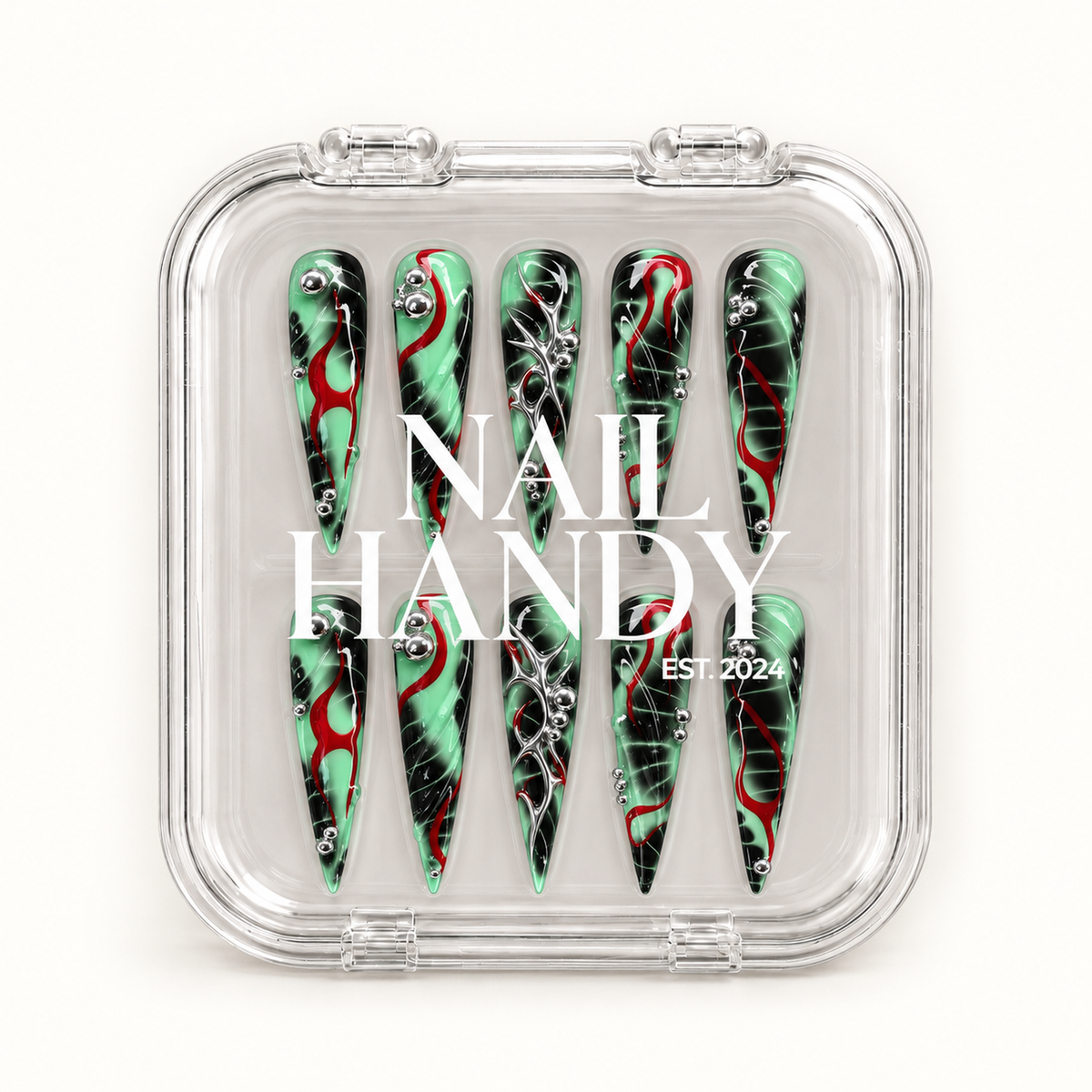 Closed clear Nail Handy case displaying ten mint green and black pointed nails with red curves and silver details beneath white branding.