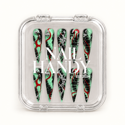 Closed clear Nail Handy case displaying ten mint green and black pointed nails with red curves and silver details beneath white branding.