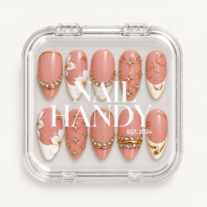 Closed clear Nail Handy case displaying ten blush-pink nails with raised white florals, clear gems, and gold-tone detailing.