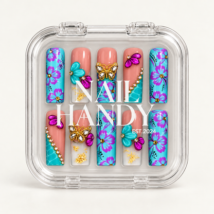 Closed clear Nail Handy case displaying ten turquoise floral and coral pink nails beneath white lettering on the lid.