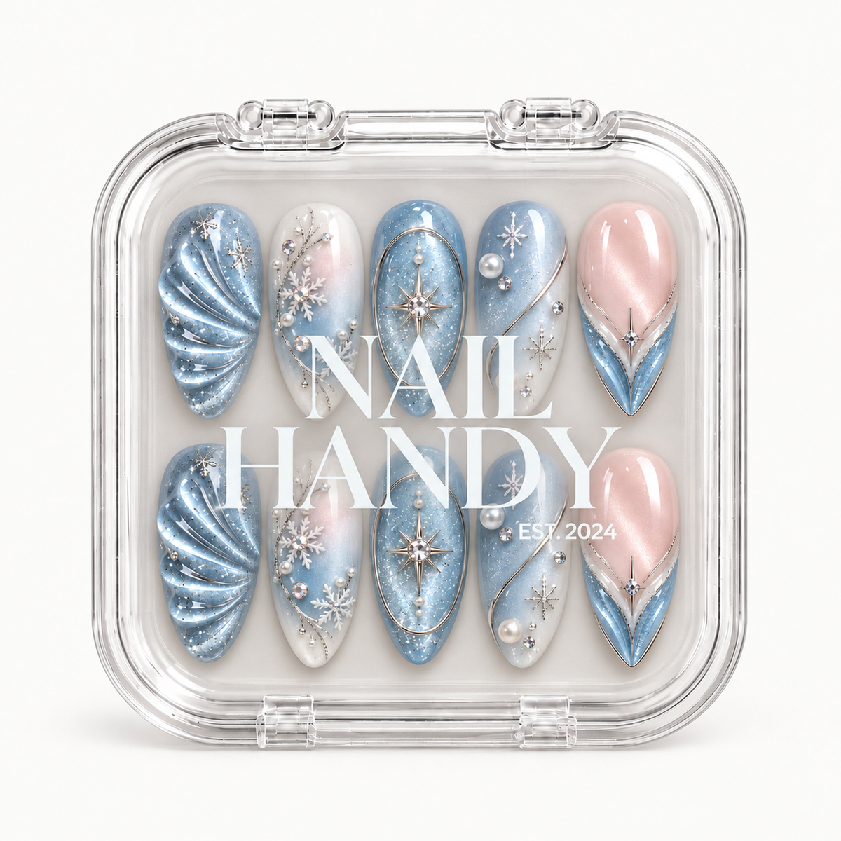 Closed clear Nail Handy case displaying ten blue, white, and blush pink winter nails in two rows beneath white lettering on the lid.