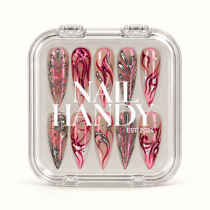 Closed clear Nail Handy case displaying ten coordinated pink and silver abstract nails beneath white branding on a light background.
