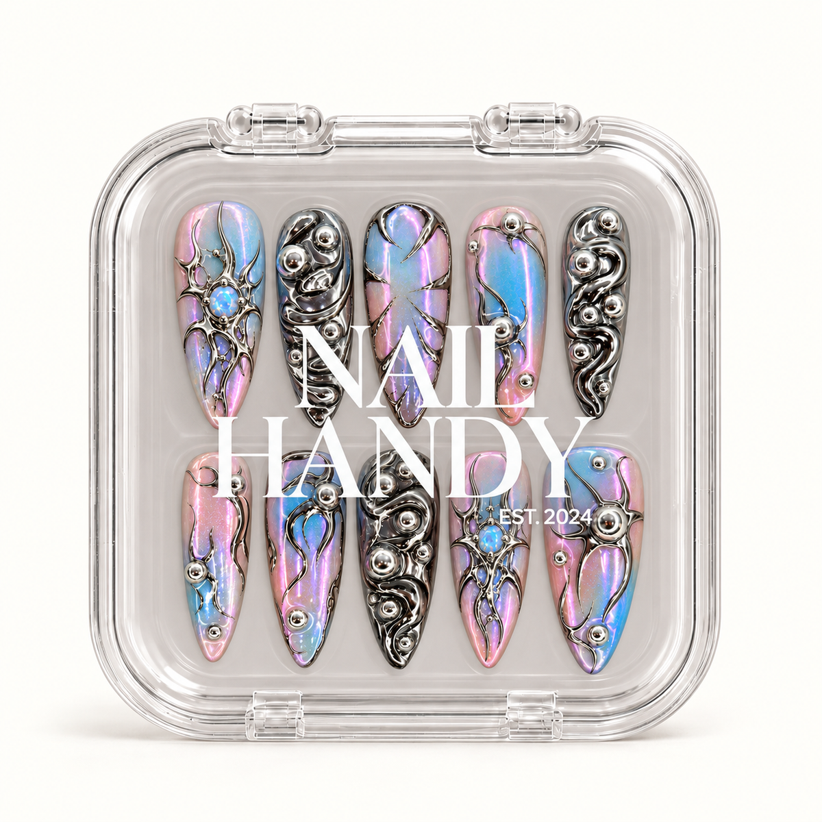 Closed clear Nail Handy case displaying ten iridescent pink, lavender, and blue nails with reflective silver ornamentation beneath white lid lettering.