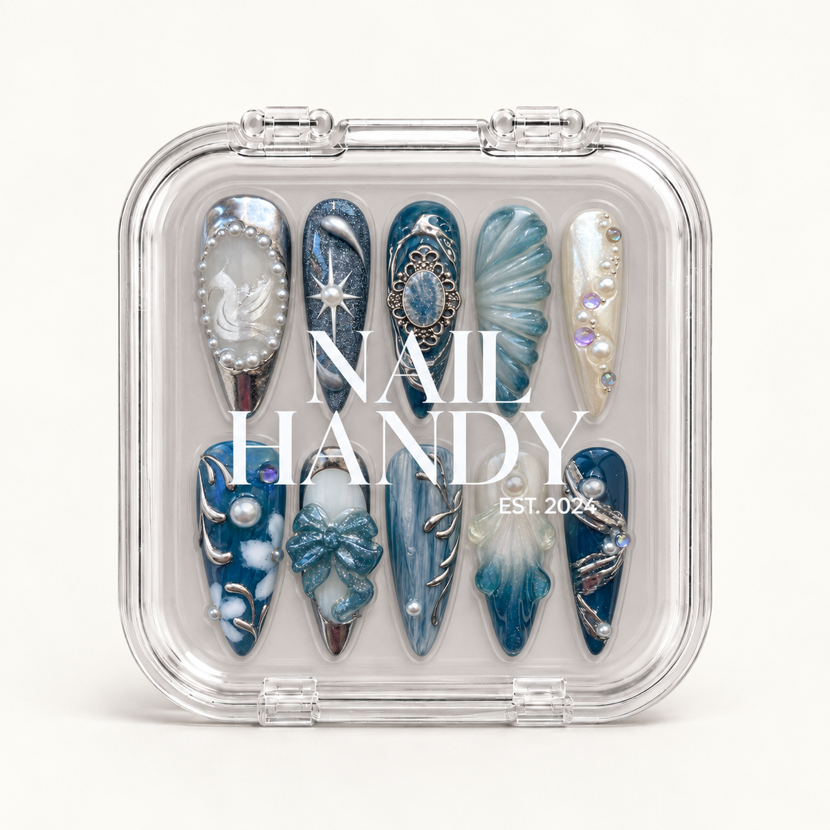 Closed clear Nail Handy case displaying ten coordinated blue, teal, and pearl white nails beneath white branding on the lid.
