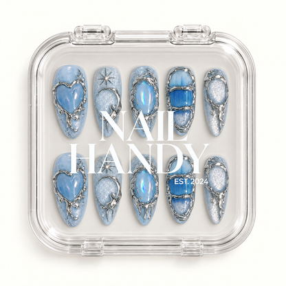 Clear Nail Handy package showing ten icy blue nails with silver-tone outlines beneath the branded lid.