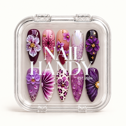 Closed clear Nail Handy case displaying ten purple and pink floral nails beneath white branding on the lid.