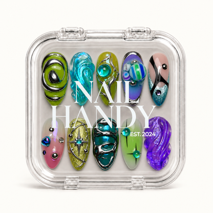 Closed clear case with white Nail Handy lettering, displaying ten colorful nails with sculptural waves, silver-colored accents, and starburst motifs.