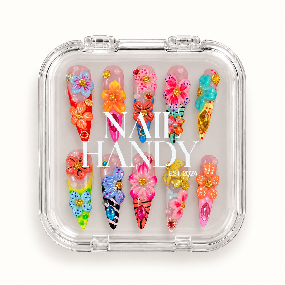 Closed clear Nail Handy case displaying ten multicolor floral nails, with white branding across the lid on a light background.