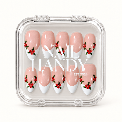 Closed clear Nail Handy case displaying ten pink shimmer French tip nails with red berries and green holly leaves in two rows.