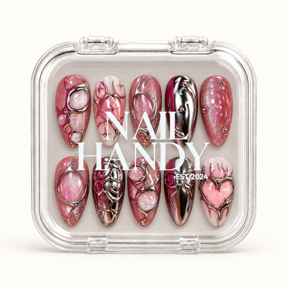 Closed clear Nail Handy case displaying ten pink and silver nails in two rows beneath white branding on the lid.