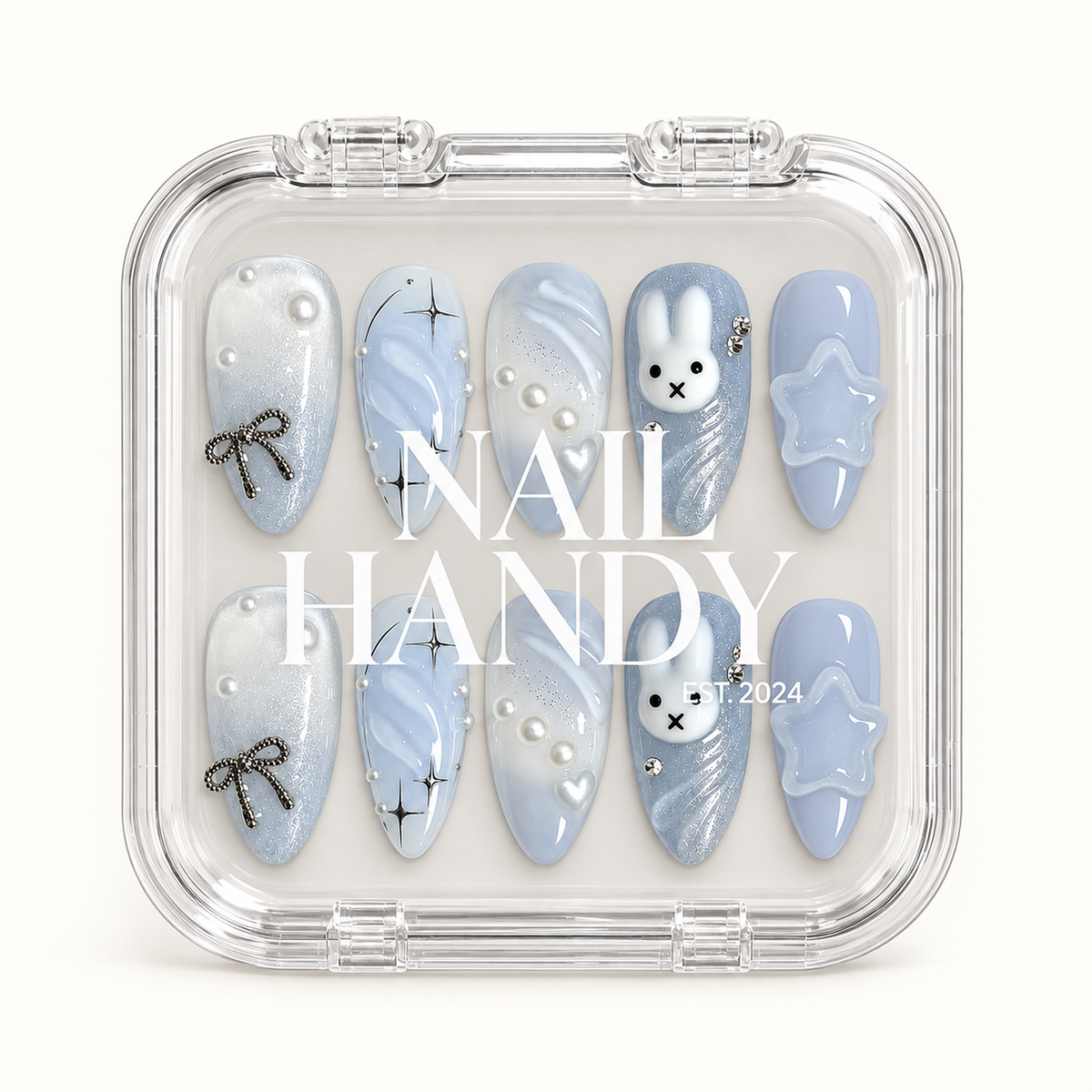 Clear Nail Handy case showing ten coordinated pale blue press-on nails beneath the branded lid.