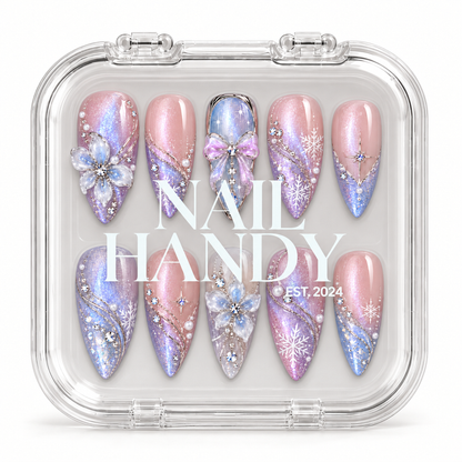 Closed clear Nail Handy case displaying ten pink, lavender, and icy blue nails beneath white branding on the lid.