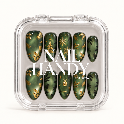 Closed clear Nail Handy case displaying ten green Christmas nails with gold-colored snowflakes, a tree, an ornament, and leafy accents.
