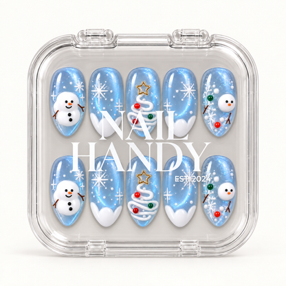 Closed clear case with white Nail Handy lettering, displaying ten icy blue nails decorated with snowmen, snowflakes, and Christmas trees.