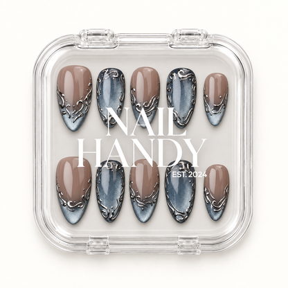 Clear Nail Handy case showing ten greige and blue-gray scrollwork nails beneath the printed brand lettering.