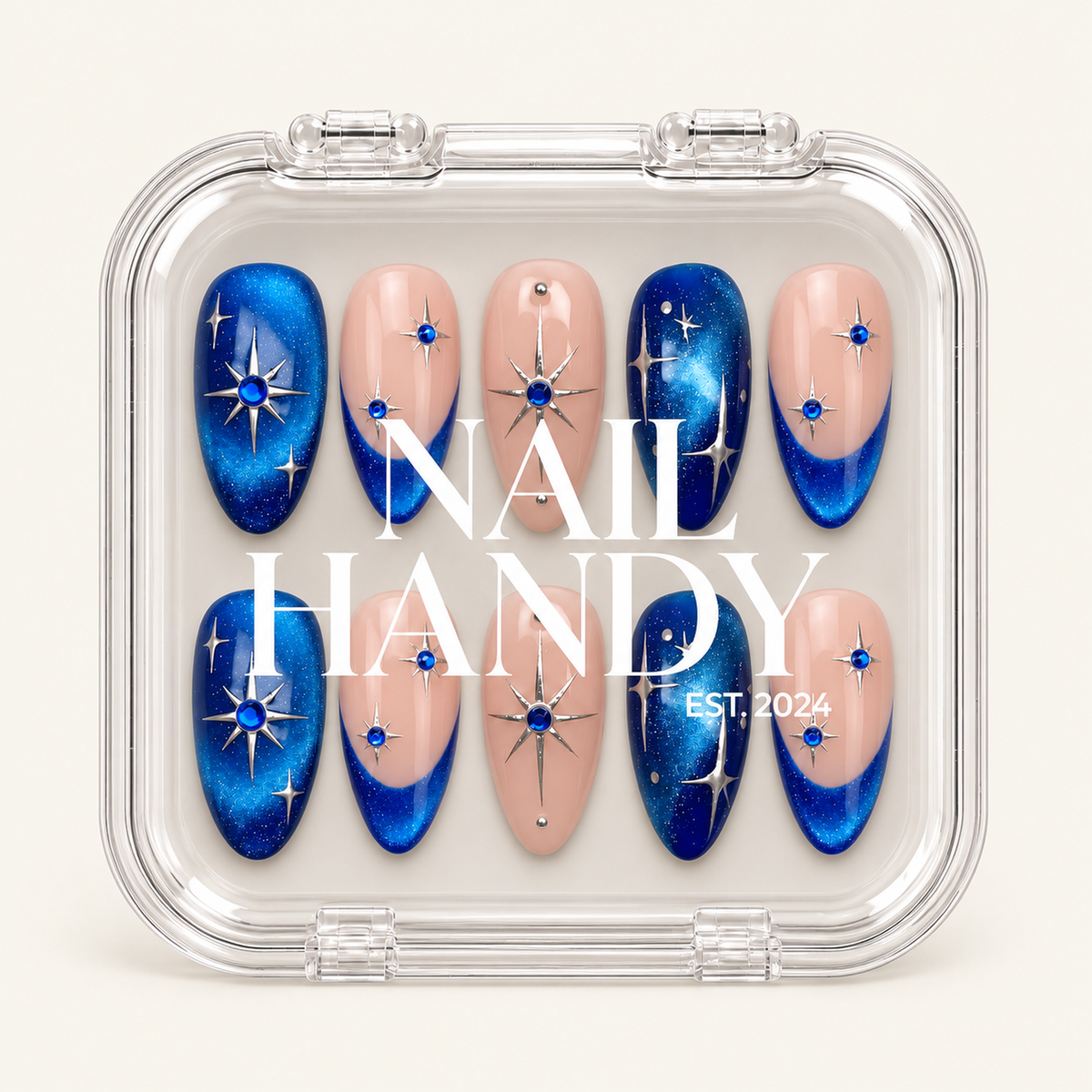 Closed clear case with white Nail Handy lettering, displaying ten blush pink and shimmering blue celestial nails on a light background.
