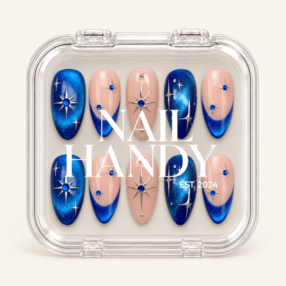 Closed clear case with white Nail Handy lettering, displaying ten blush pink and shimmering blue celestial nails on a light background.