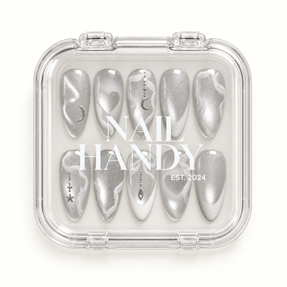 Closed clear case with white Nail Handy lettering displaying ten coordinated silver and white nails on a pale background.