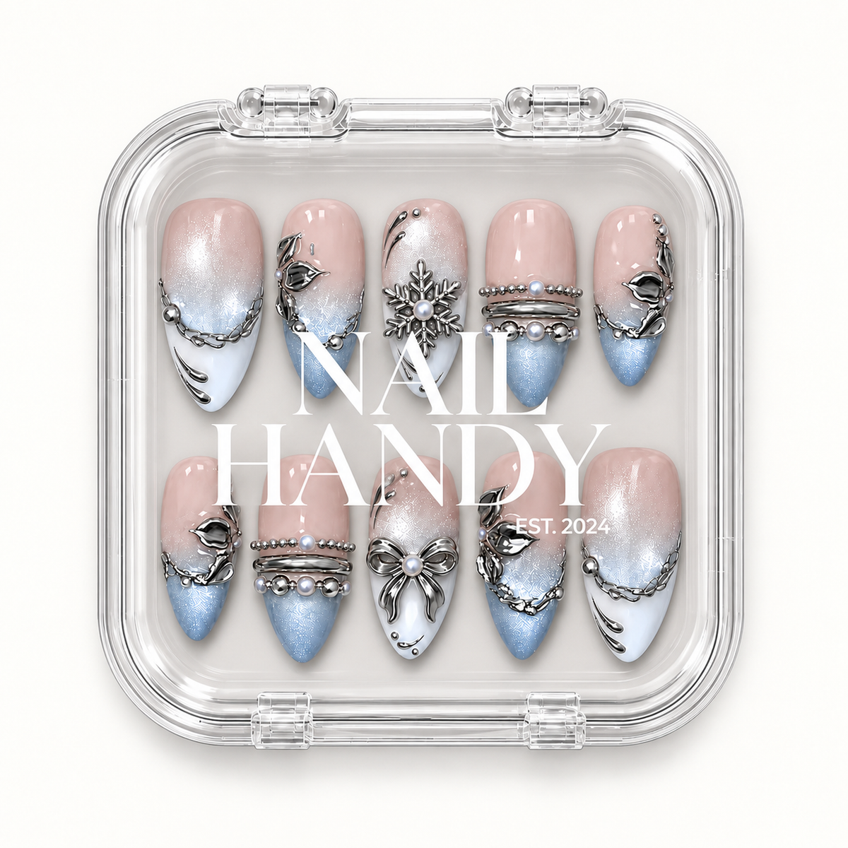 Ten Blush Snowfall nails displayed in a clear case with Nail Handy lettering across the center.