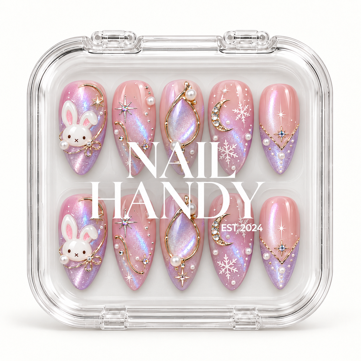 Closed clear case with white Nail Handy lettering, displaying ten pink and lilac shimmer nails with bunny accents and winter celestial details.