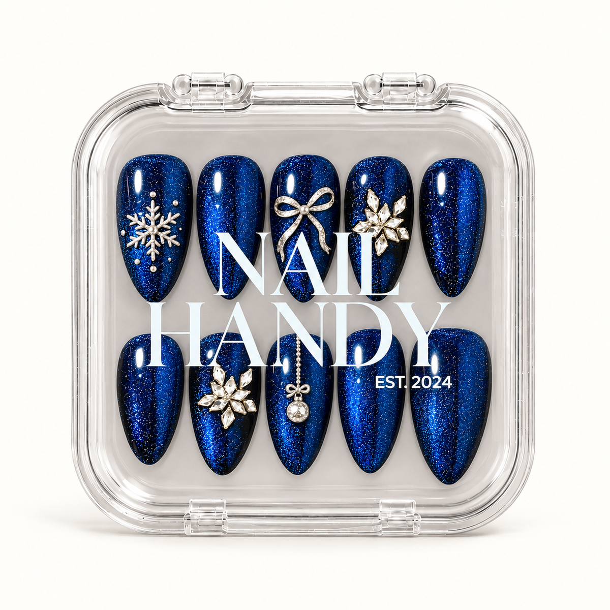 Closed clear Nail Handy case displaying ten blue shimmer nails with snowflake, bow, floral jewel-cluster, and ornament details.