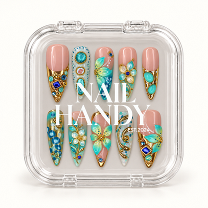 Closed clear Nail Handy case displaying ten blush pink and turquoise decorated nails beneath white branding on the lid.