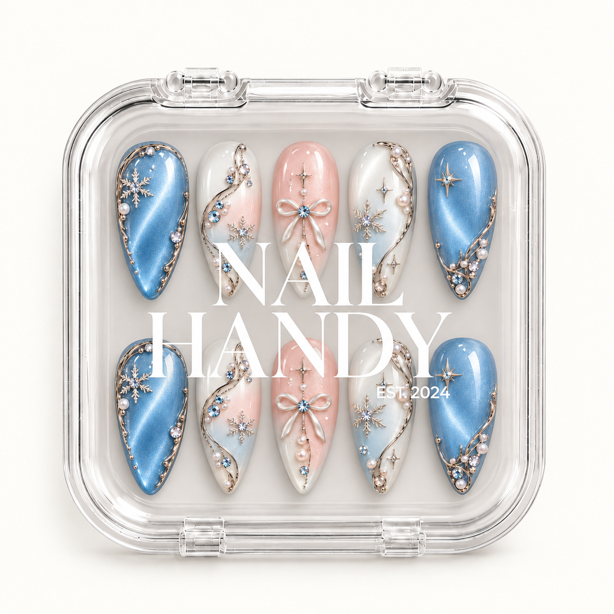 Closed clear case with white Nail Handy lettering, displaying ten coordinated winter nails with blue shimmer, pink bows, and snowflakes.