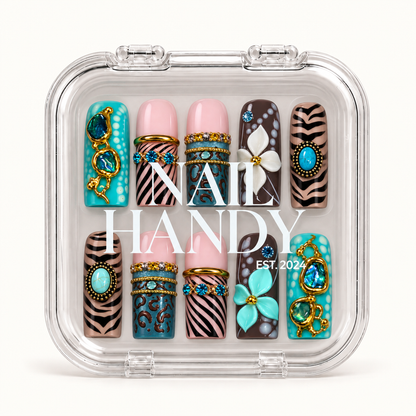 Closed clear Nail Handy case displaying ten decorated nails in two rows, with turquoise accents, animal patterns, raised flowers, and gold-tone details.