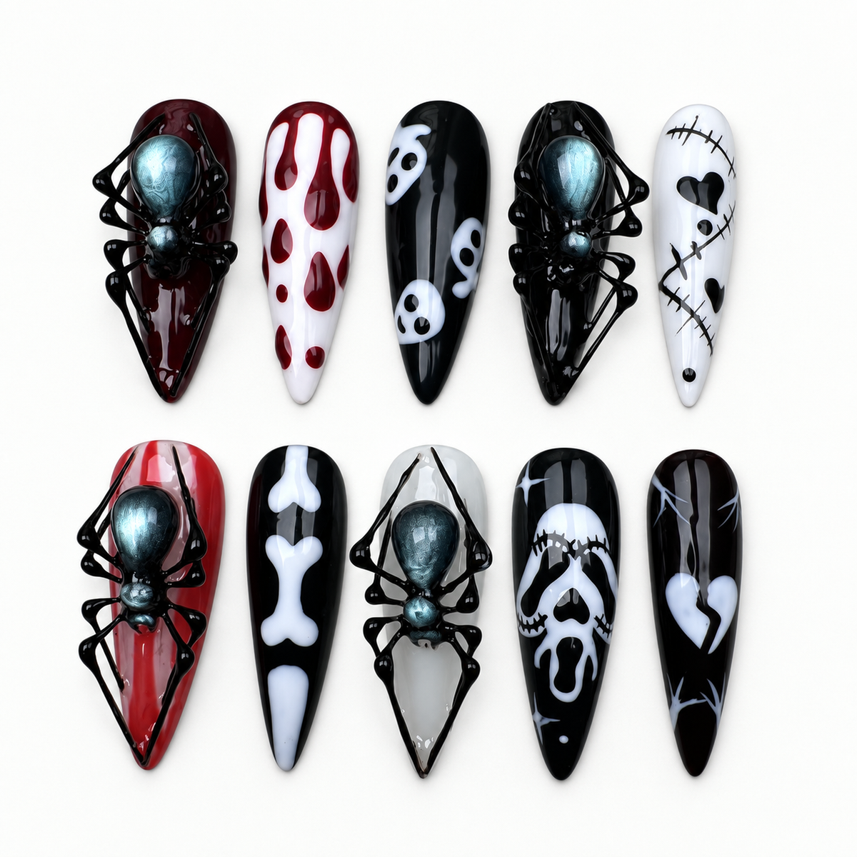Ten glossy gothic press-on nails arranged on a light textured surface, featuring raised black spiders, webs, white bones, ghostly faces, and deep red accents.