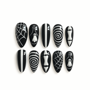 Black-and-white gothic press-on nail set with web, ghostly bottle, spiral, stripe, and bone-inspired artwork.