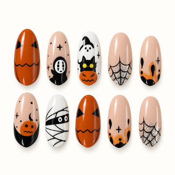 Pumpkin Web Parade press-on nail set arranged on a textured pale surface, featuring orange pumpkins, black spooky graphics, white accents, and silver spiderweb glitter.