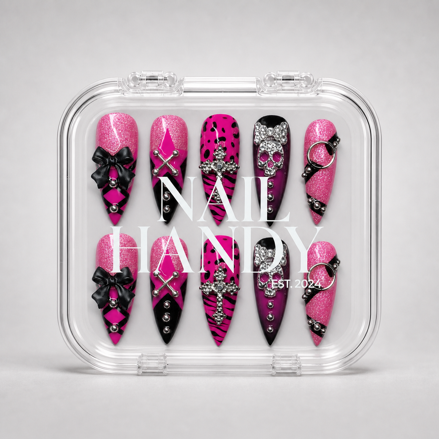 Pink Noir Charm press-on nails presented with the Nail Handy brand package box.