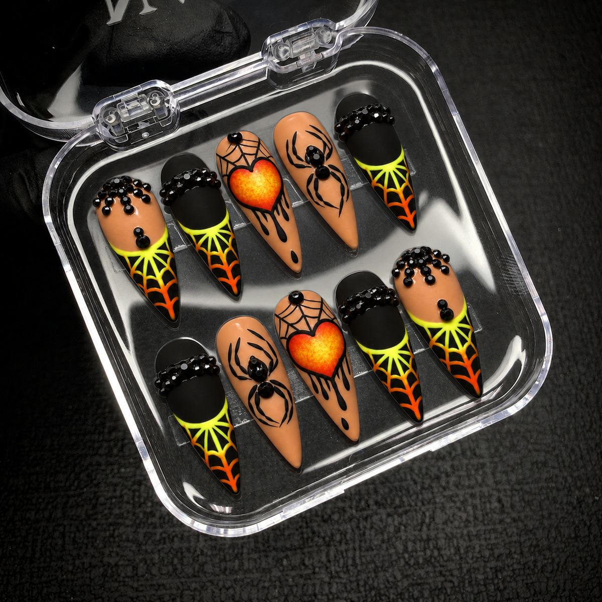 Open Nail Handy package box showing the Midnight Web Heart press-on nail set and its coordinated black-and-orange artwork.