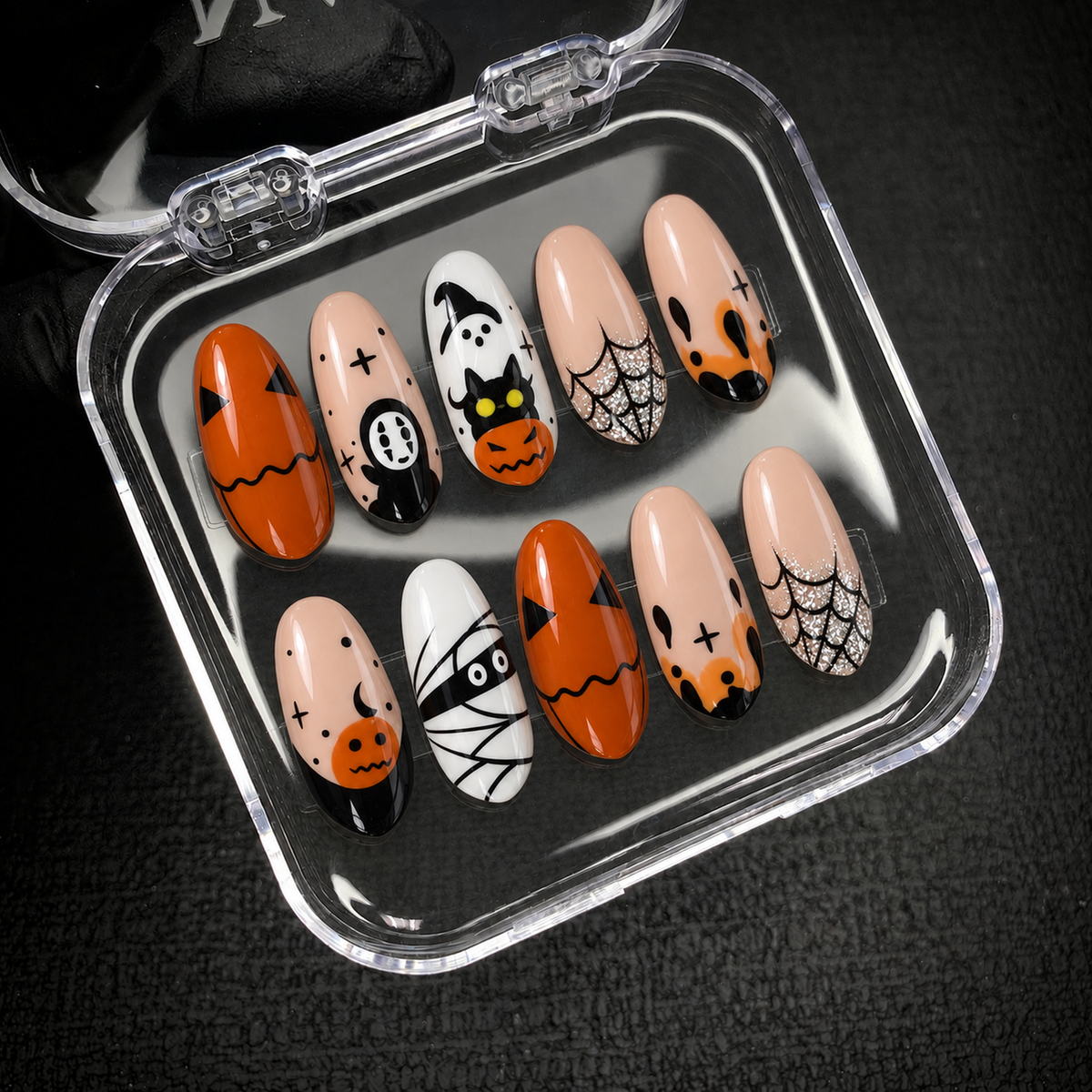 Open Nail Handy package displaying the Pumpkin Web Parade press-on nail set and included presentation materials.