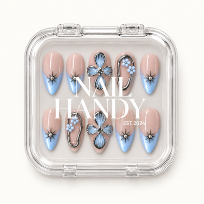 Clear Nail Handy case displaying ten blush-nude and icy-blue floral nails, with the brand name across the front.