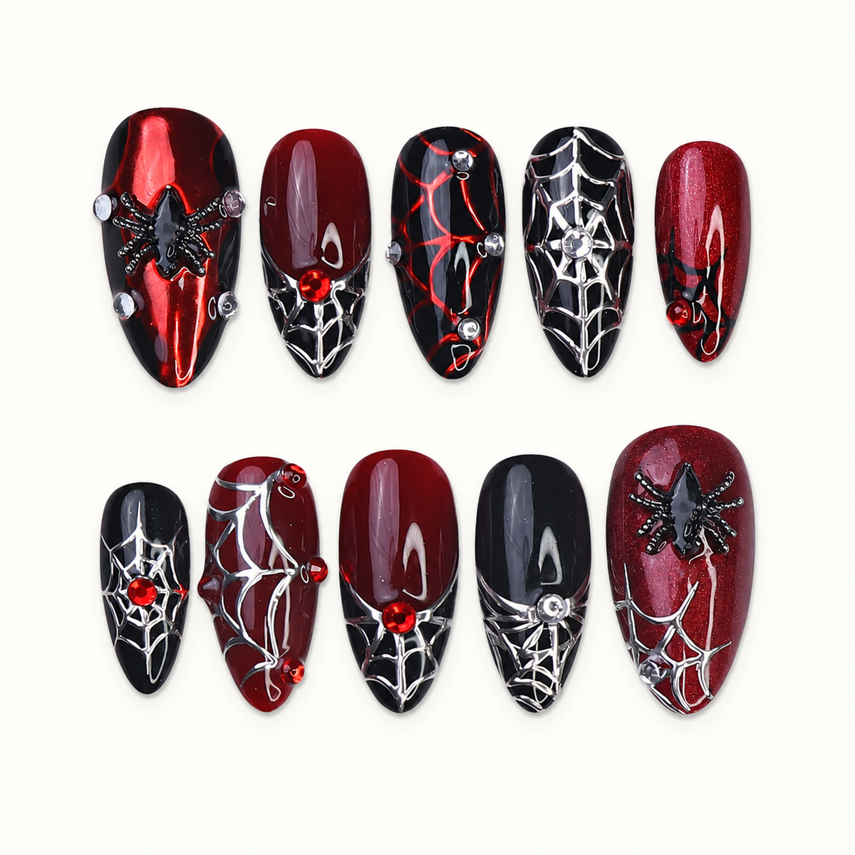 Ten coordinated crimson red and black press-on nails with silver spiderweb linework, raised spider accents, and red gem-like details on a light neutral background.