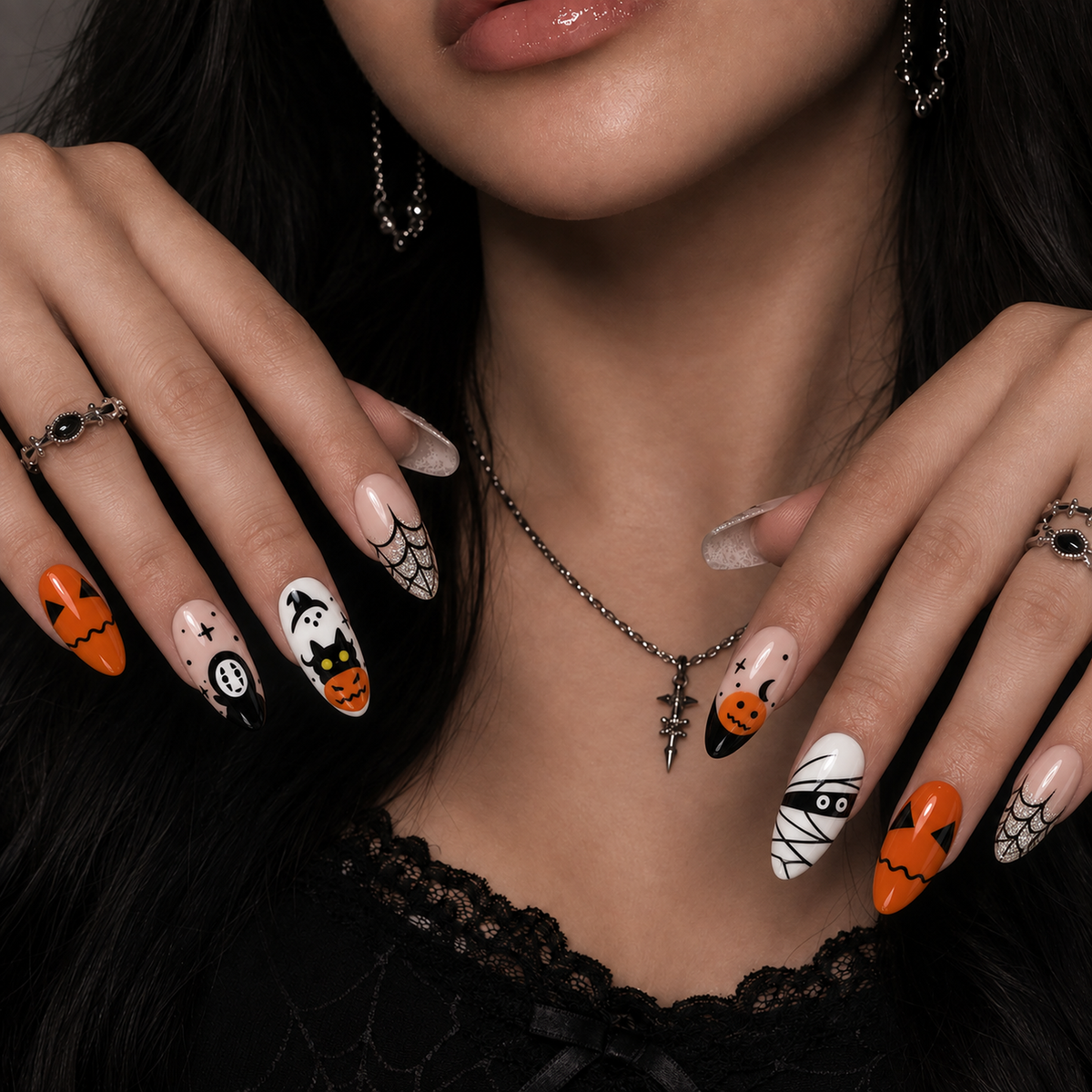 Pumpkin Web Parade press-on nails shown on a hand model, highlighting orange pumpkin art, nude accents, black linework, and spiderweb details.