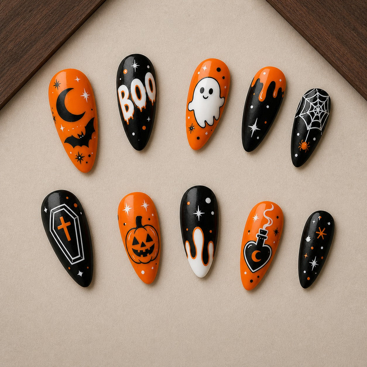 Boo Lantern Halloween press-on nail set displayed in a walnut tray — almond shape