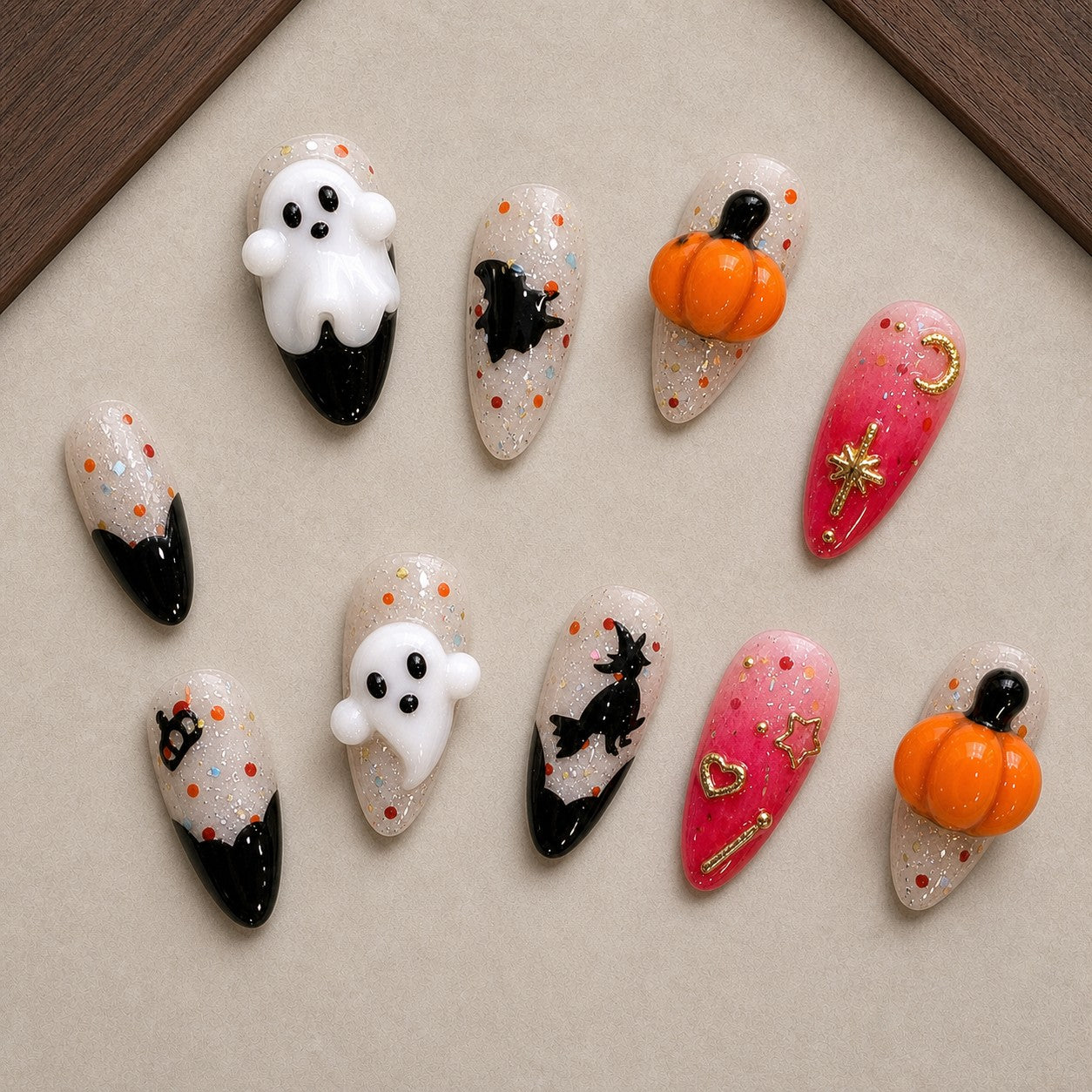 Broomstick Boo Halloween press-on nail set displayed in a walnut tray — almond shape
