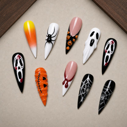 Candy Corn Scream Halloween press-on nail set displayed in a walnut tray — stiletto shape
