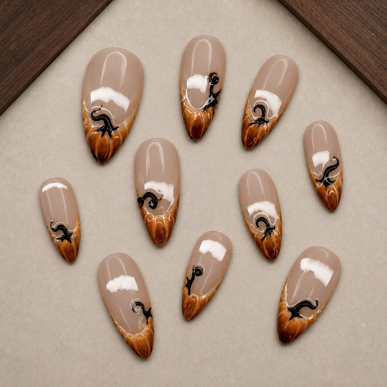Caramel Drip Halloween press-on nail set displayed in a walnut tray — almond shape