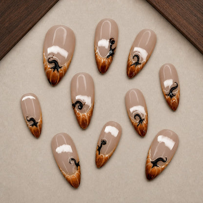Caramel Drip Halloween press-on nail set displayed in a walnut tray — almond shape